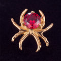 Antares — A gold spider with a garnet heart