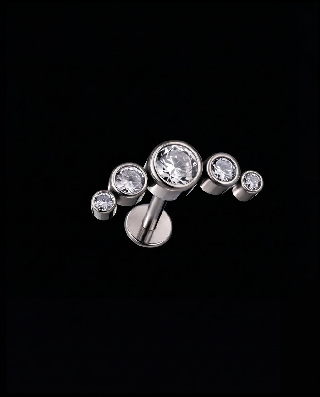 Lyra — Five bezel-set stones in a rising arc