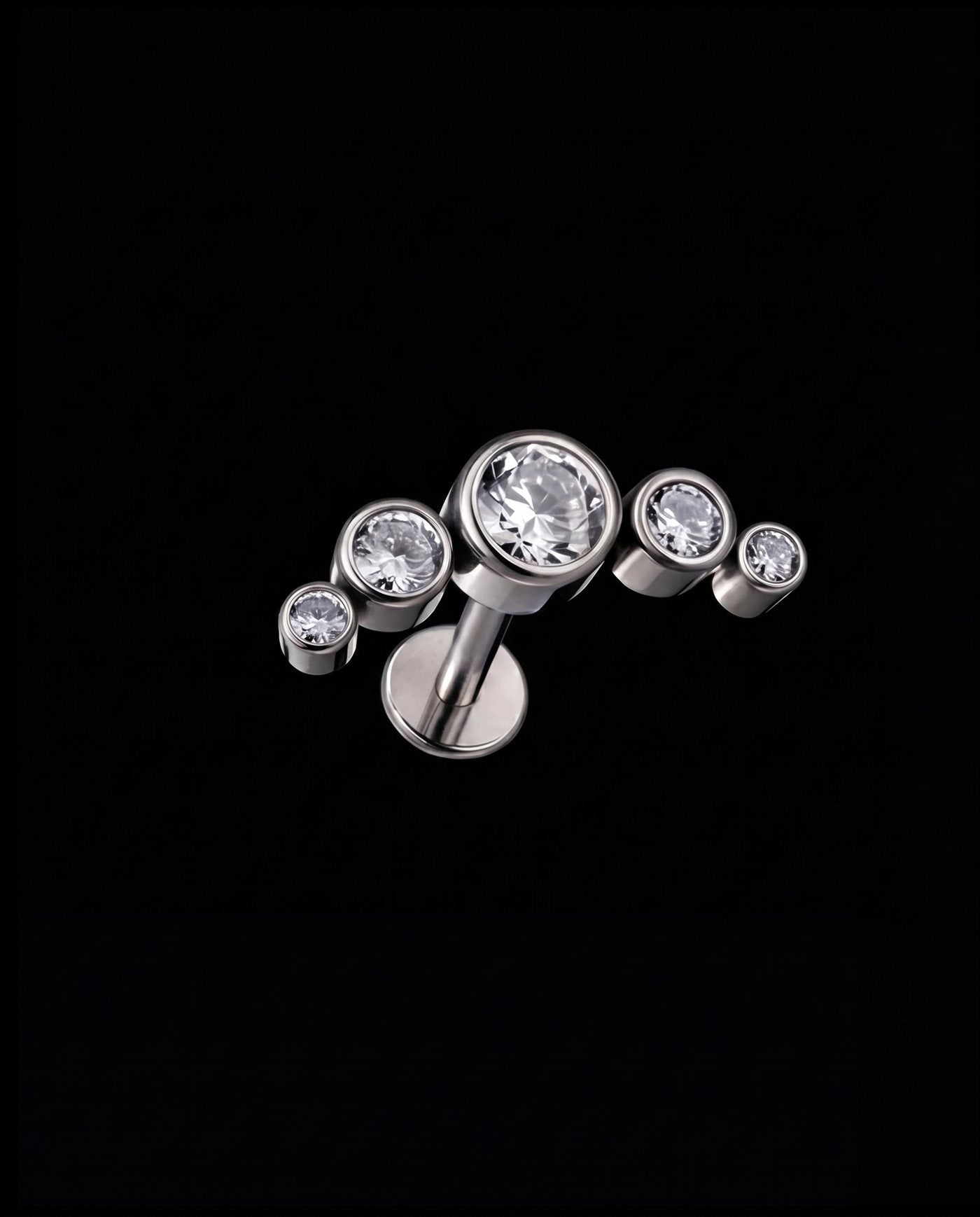 Lyra — Five bezel-set stones in a rising arc