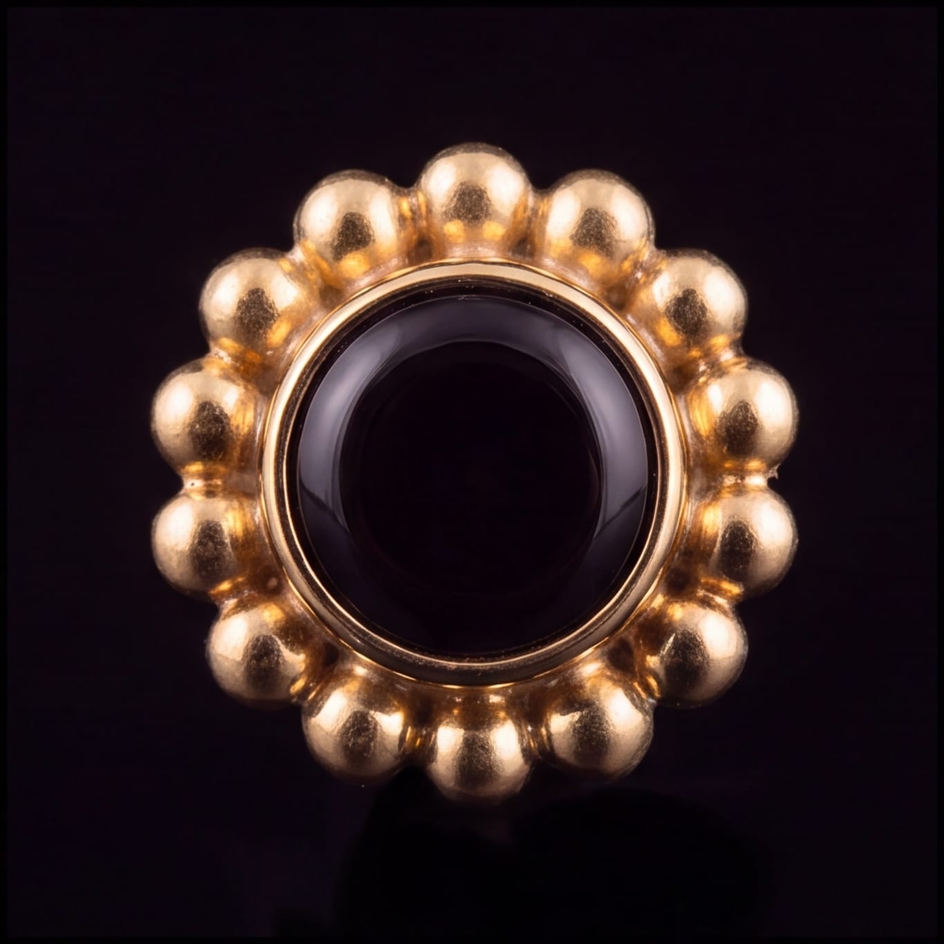 Anemone — black agate in gold PVD titanium, front