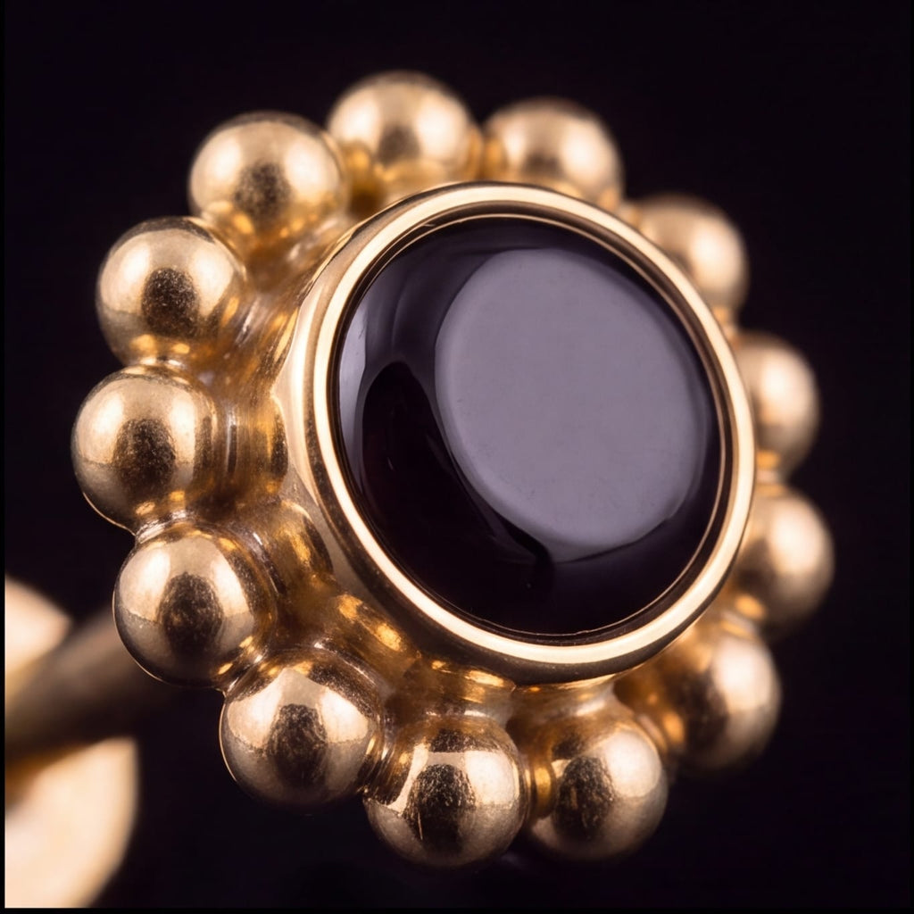 Anemone — black agate in gold PVD titanium, angled